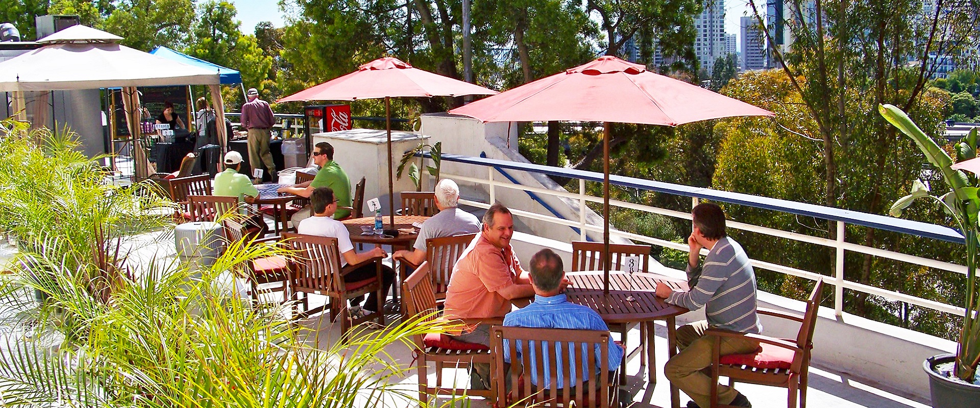 Several groups of people sitting at tables at the Alaska Airlines Flight Path Grill.