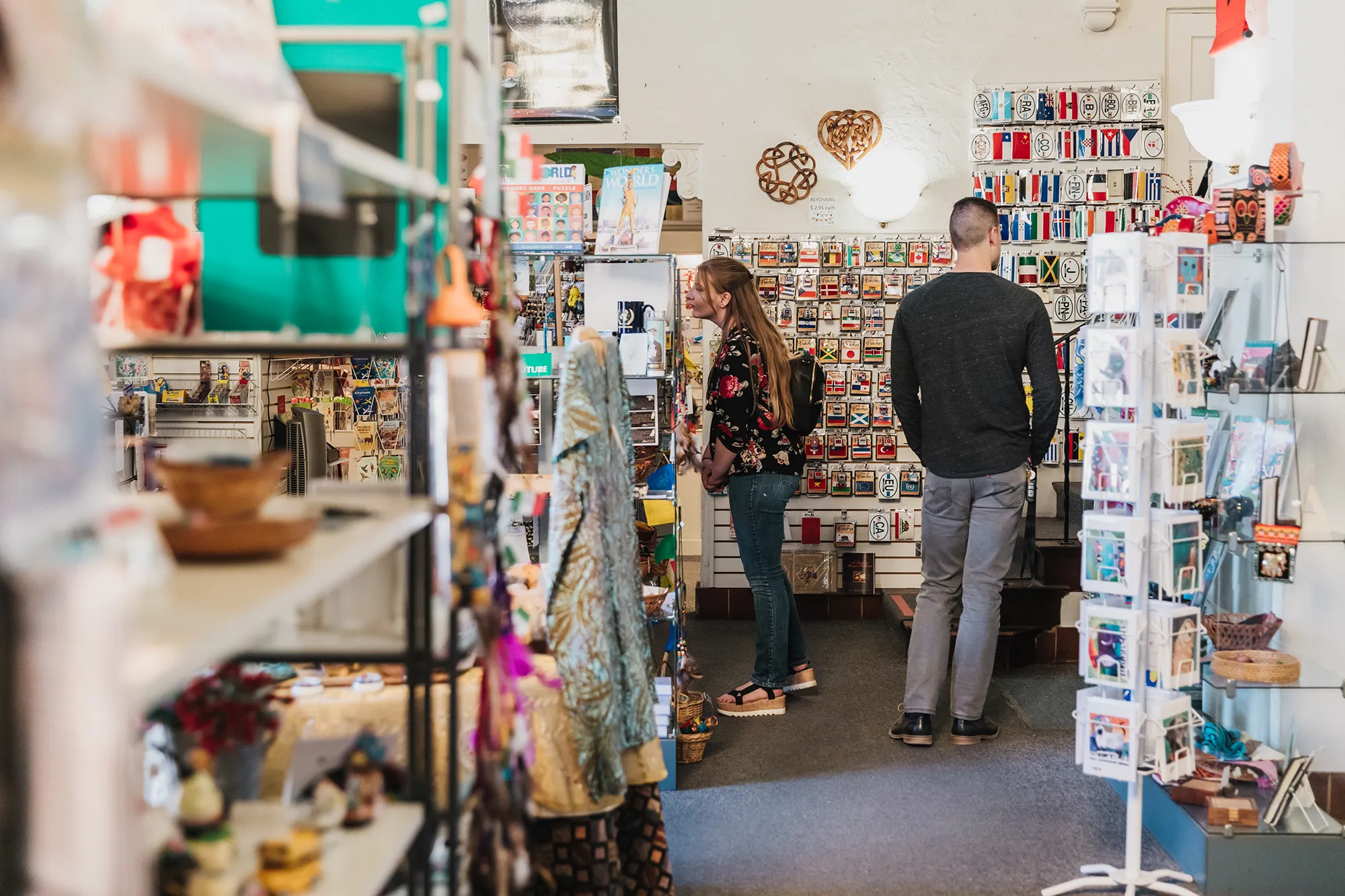 Two adults looking at items to purchase in the United Nations Building and Gift Shop.