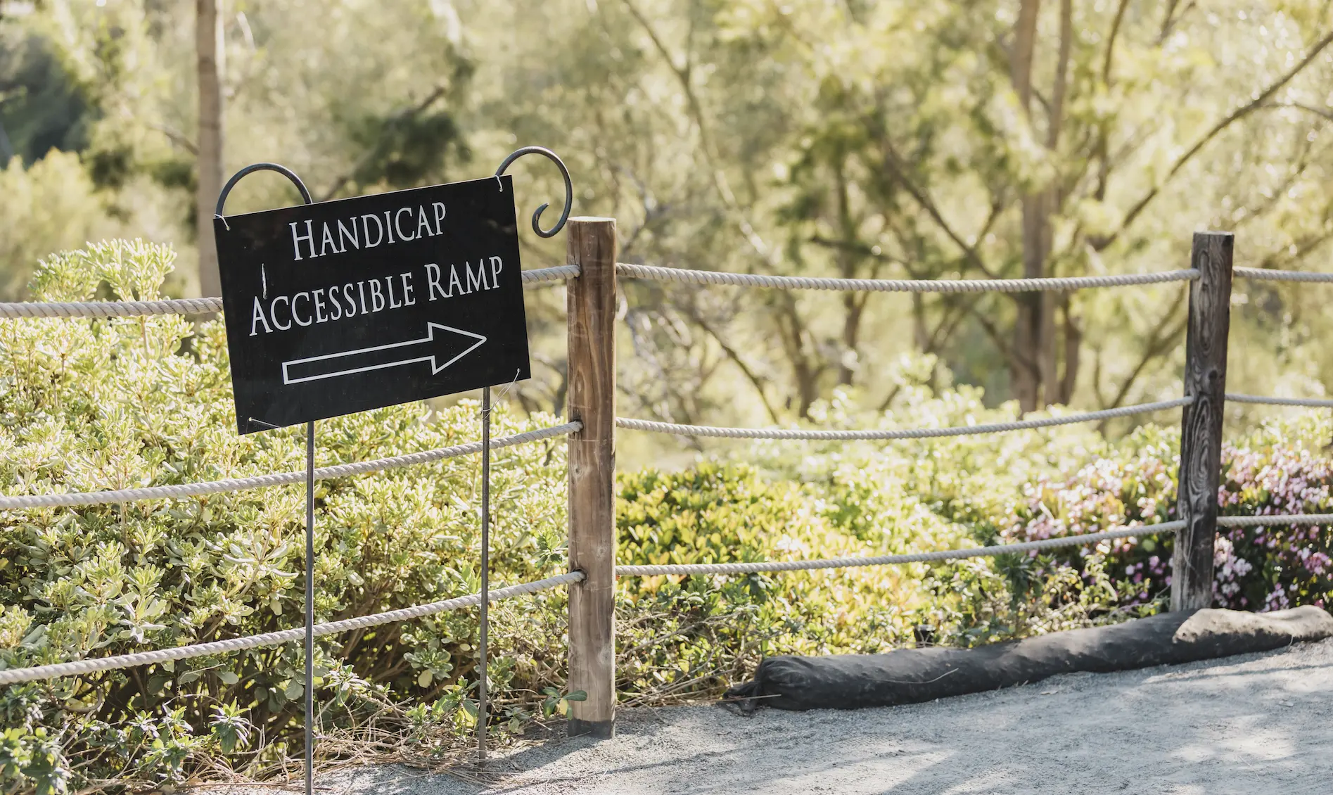 Handicap Accessible Ramp sign with an arrow pointing down a ramp.