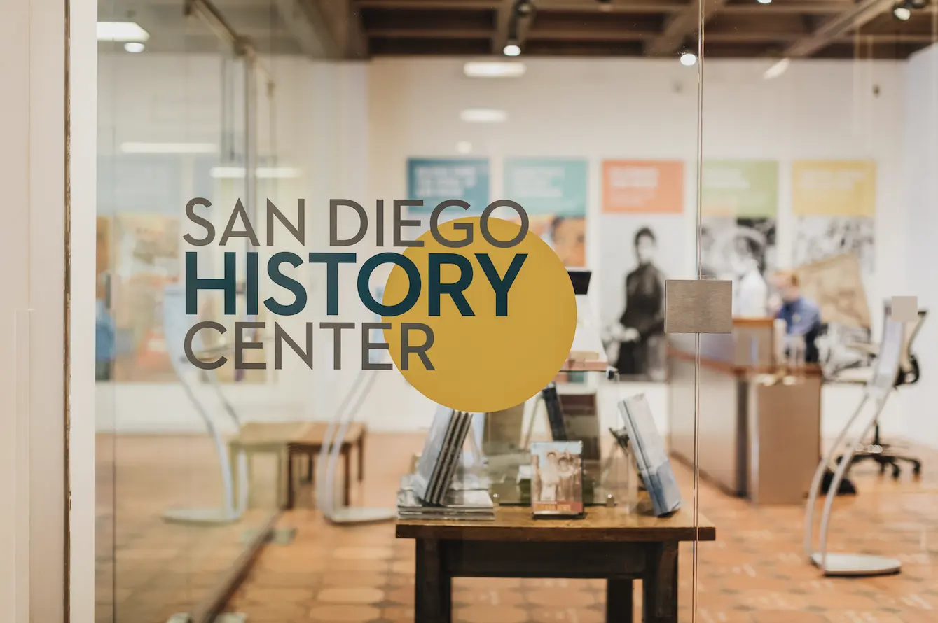 San Diego History Center logo on a glass door that leads into the musuem.